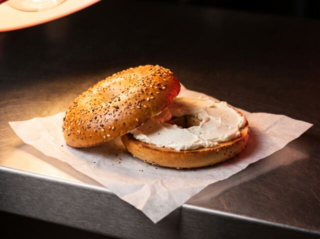 A toasted everything bagel with cream cheese